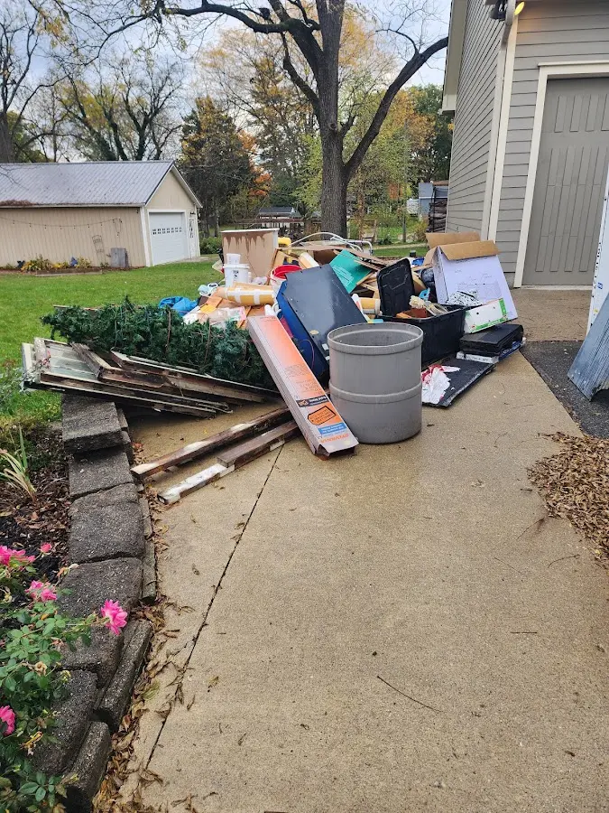 Dumpster being loaded with debris for Commercial Dumpster Rental in Prunedale